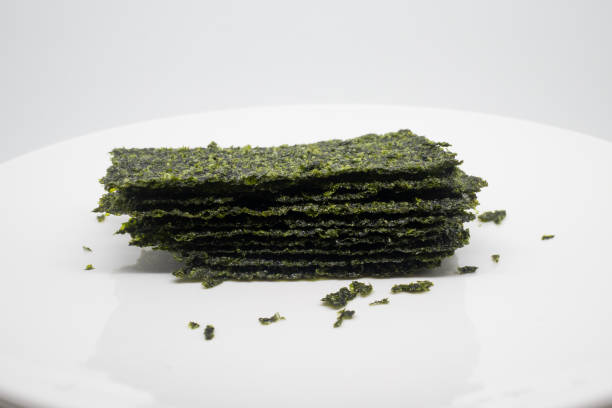 Seaweed sheets on a white plate as a nutritious snack.