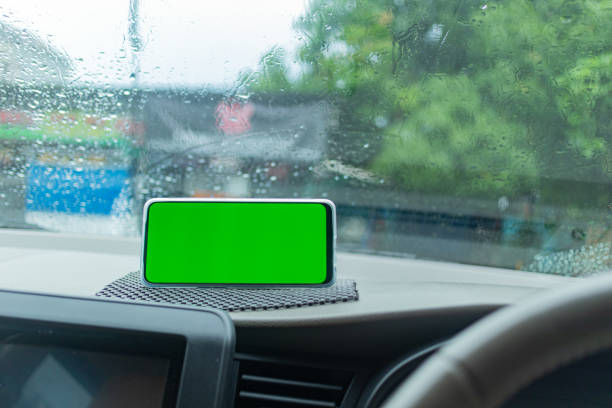 istock Smartphone with Green Screen on Dashboard in Rainy Car 2182036657