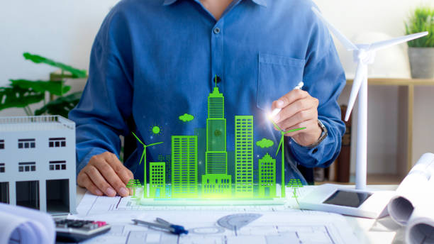 istock An architect designs a sustainable city using a holographic projection, surrounded by blueprints and green building models. Eco-friendly building. modern city. Green Business. Sustainable energy. 2182038034
