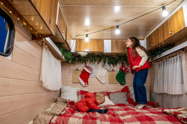 istock Siblings Enjoy Festive Fun in Decorated Camper 2182041524