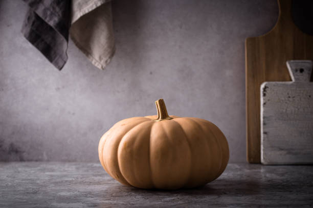Raw fresh cut pumpkin on dark background, dark mood style