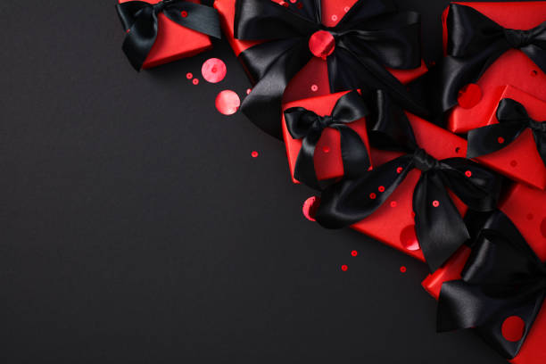 istock Black Friday sale concept. Red gift boxes with black ribbon bow on dark background. 2182043756