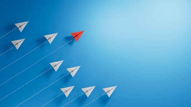 istock Paper planes with one red individual going in upward direction with blue background - 3D illustration.3D rendering on blue background. 2182044336