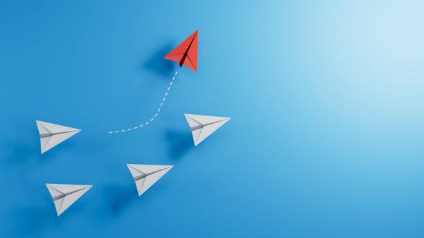istock New ideas creativity and different innovative solution. Business concept. A group of paper airplanes, one plane is flying in the other direction, different way. 2182044725