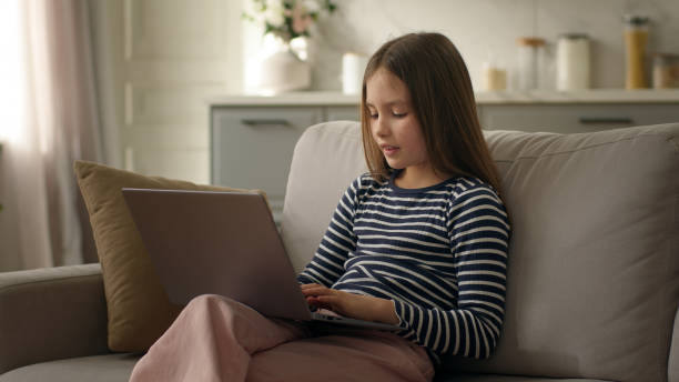 istock Little girl child using laptop computer kid schoolgirl student learning technology gadget typing studying education networking browsing scrolling connected pupil development electronic internet home 2182045192