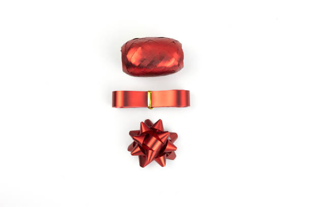 Top view, Gift box decorations, bows, ribbons and ropes in red color isolated on a white background. Concept for gift box decorative.