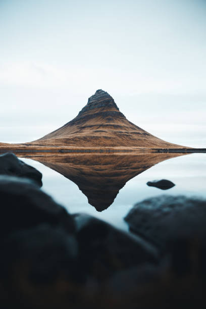 istock Kirkjufell Mountain Reflected in Calm Lake with Foreground Rocks, Iceland 2182046272