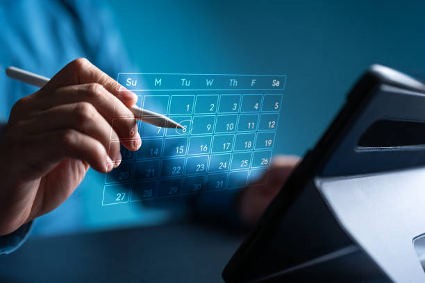 istock Calendar on virtual screen application. Businessman manages time for effective work. Make an appointment, action plans, highlight reminders and meeting agenda on the calendar. Time management concept. 2182046549