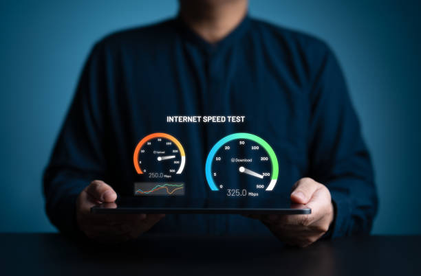 istock Fast internet connection speed test. A man uses a tablet to check the bandwidth of wireless networking or 5G cellular Mbps or Gbps speed quality. Wi-Fi 7 network download or upload transfer rate. 2182046583