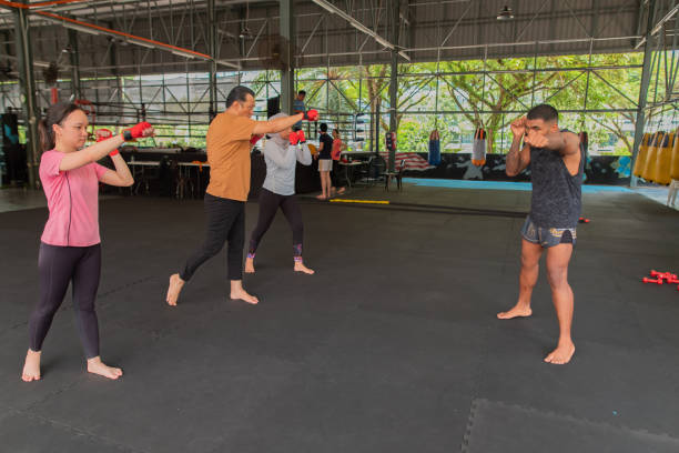istock Group of different races students learn kickboxing with gym instructor stock photo 2182048297