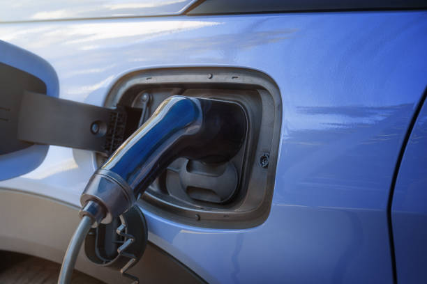 istock Blue electric car with charging port 2182050020