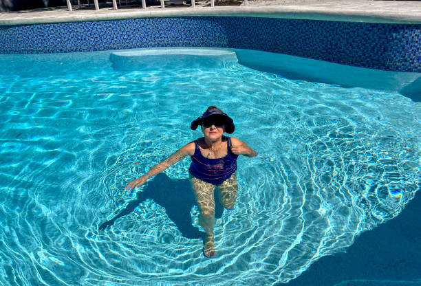 istock Attractive Hispanic senior woman in pool 2182052953