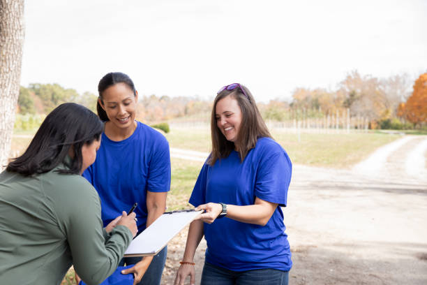 istock Advisor attends charity volunteer drive sign ups with diverse clients 2182054471