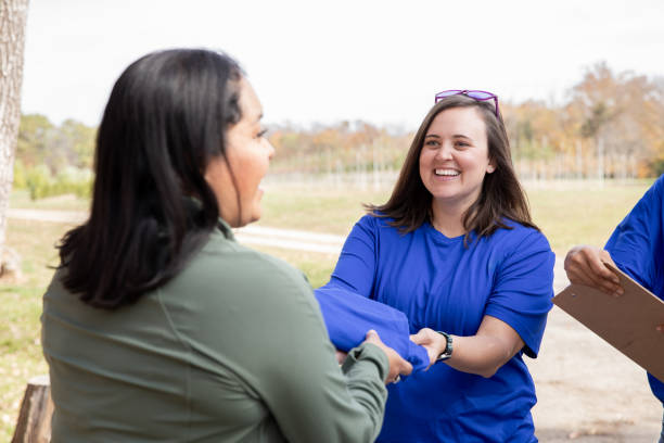 istock Advisor attends charity volunteer drive sign ups with diverse clients 2182054568