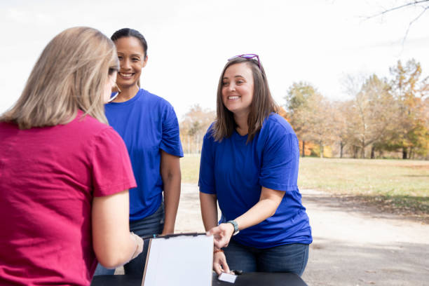 istock Advisor attends charity volunteer drive sign ups with diverse clients 2182054824