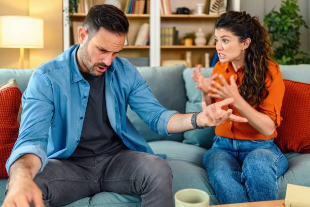 istock Mid adult couple arguing on sofa at home. 2182056564