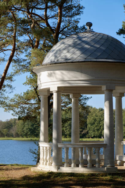istock Serene lakeside rotunda amidst pines 2182059276