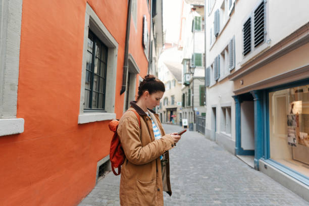 istock Female tourist using mobile phone while on a city break vacation 2182061219