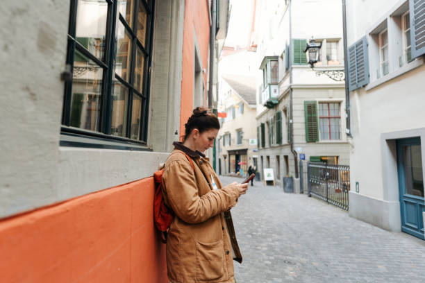 istock Female tourist using mobile phone while on a city break vacation 2182061222