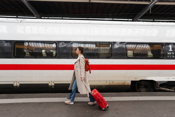 istock Woman in a rush at the train station 2182061228