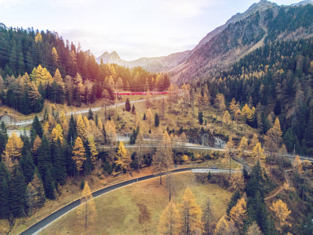 istock Winding Mountain Road with Train in Autumn Forest 2182063033