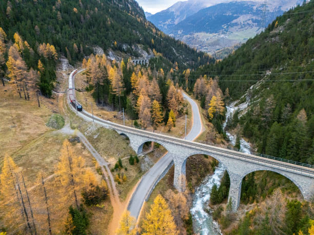 istock Alpine Roads and Railway Viaduct Amidst Autumn Forest 2182063218