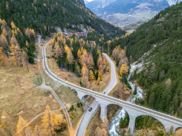 istock Alpine Roads and Railway Viaduct Amidst Autumn Forest 2182063235