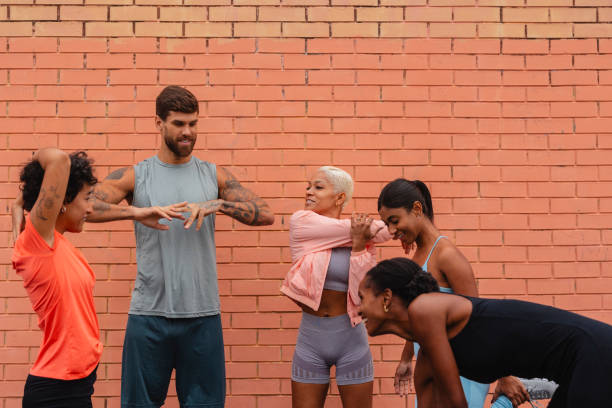 istock Group of athletes stretching together before urban training 2182064369