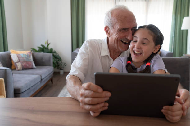 istock Grandfather and granddaughter using tablet 2182064453