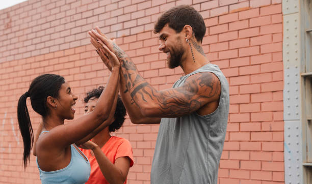 istock Athletes giving high five after successful urban training 2182064806