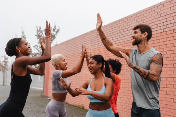 istock Group of athletes giving high five after successful training in city 2182064818