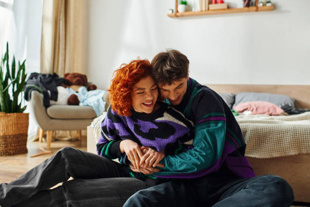 istock A joyful young couple embraces while relaxing on a cozy floor at home during a sunny afternoon 2182064925