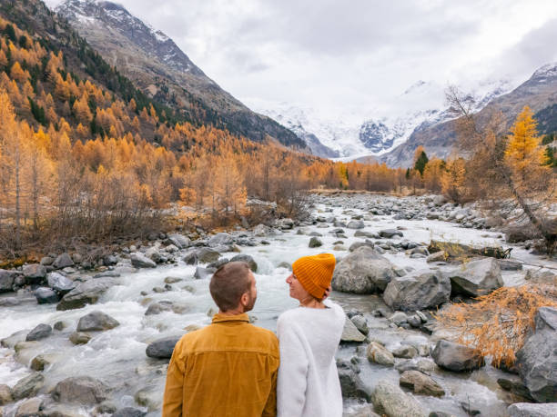 istock Couple Embracing by Mountain River in Autumn Landscape 2182064929