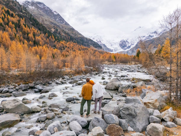 istock Couple Embracing by Mountain River in Autumn Landscape 2182064981