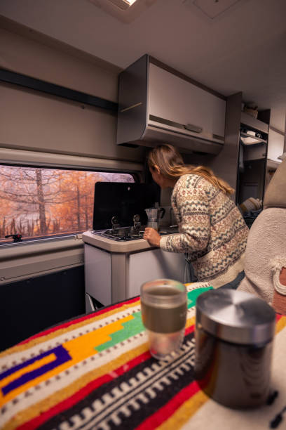 istock Woman Preparing Coffee Inside Cozy Camper Van 2182067351