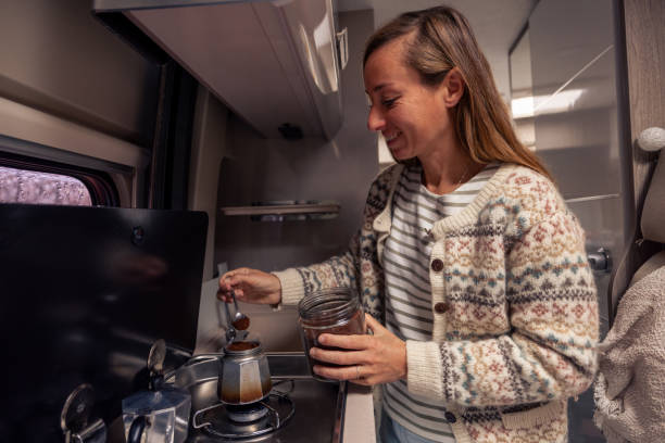 istock Woman Prepares Coffee Inside Camper on a Cozy Autumn Day 2182067482