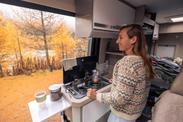 istock Woman Brewing Coffee in Cozy Camper Van with Autumn View 2182067632