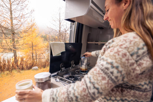 istock Woman Enjoying Coffee Preparation in Cozy Camper Van 2182067651