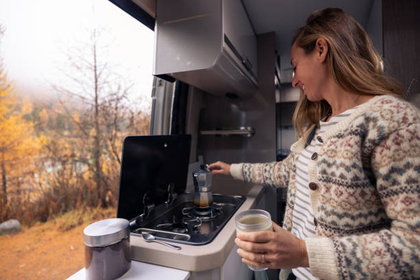 istock Woman Enjoying a Warm Coffee Moment in Camper Van 2182067778