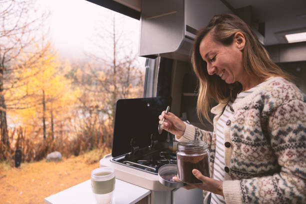 istock Woman Enjoying a Warm Coffee Moment in Camper Van 2182067830