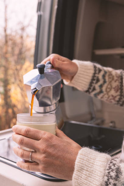 istock Pouring Fresh Coffee in Camper Van with Autumn View 2182067882