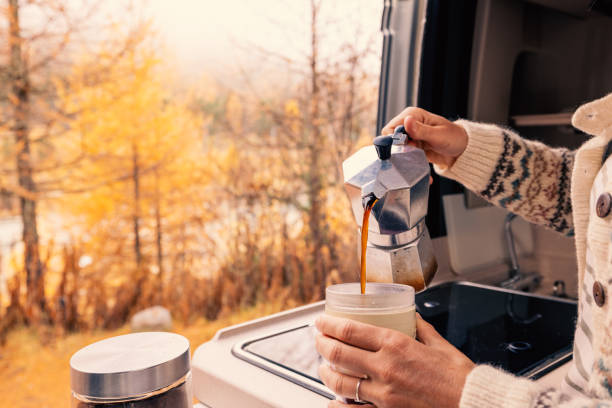 istock Pouring Fresh Coffee in Camper Van with Autumn View 2182067894