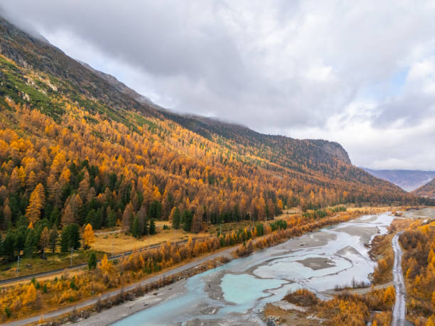 istock Autumnal River Flowing Through Alpine Valley 2182070932