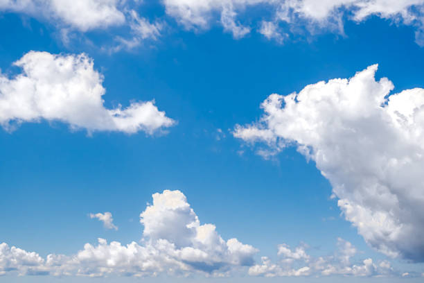 istock Clear blue sky with fluffy white clouds, design element for creative uses in graphic design, advertisements or website headers, evoking openness and tranquility for themes of freedom and relaxation. 2182072264