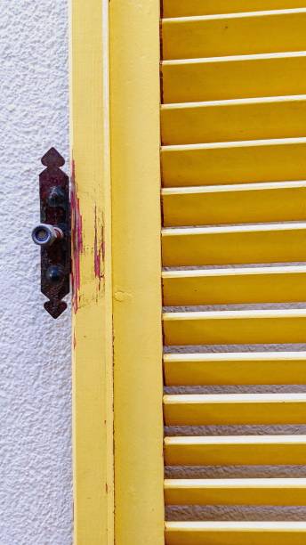 istock yellow wooden shutters 2182072619