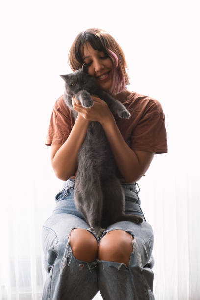 istock Young Woman And Cat 2182072926