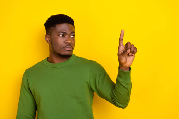 istock Portrait of attractive serious guy touching option menu copy space isolated over vibrant yellow color background 2182072964
