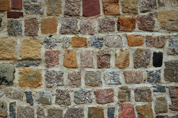 istock Old exterior building stone wall background. Naturally aged, colored bricks, no people 2182074346
