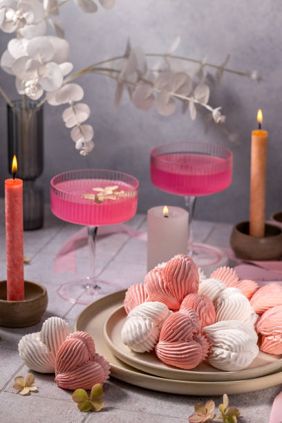 istock Heart-shaped meringues, pink cocktails and candles creating romantic atmosphere 2182074821