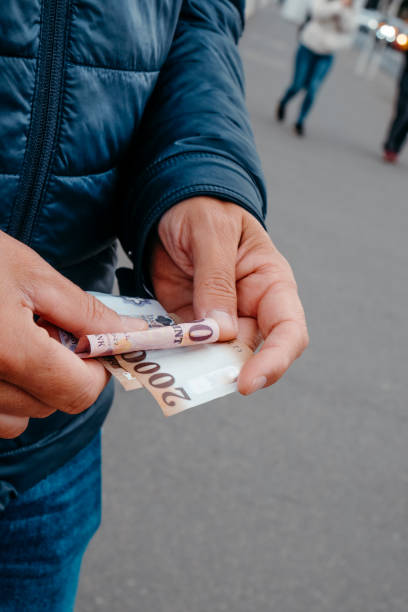 istock man with some hungarian forints in his hands 2182075402